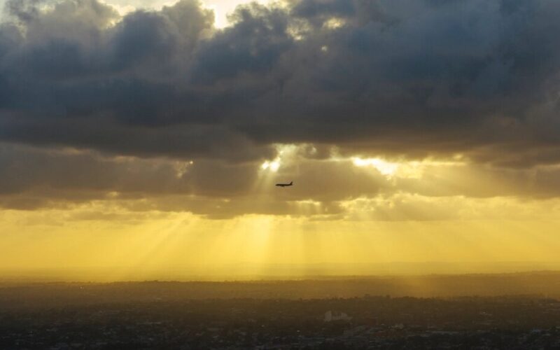 silhouette passenger plane sky sun