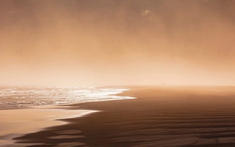 Sunrise fog wet sand beach