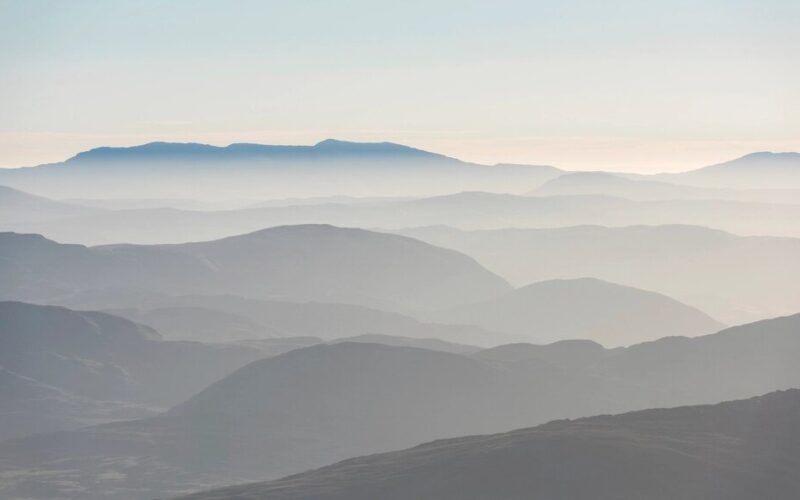 Rolling fog hilly mountains sunrise